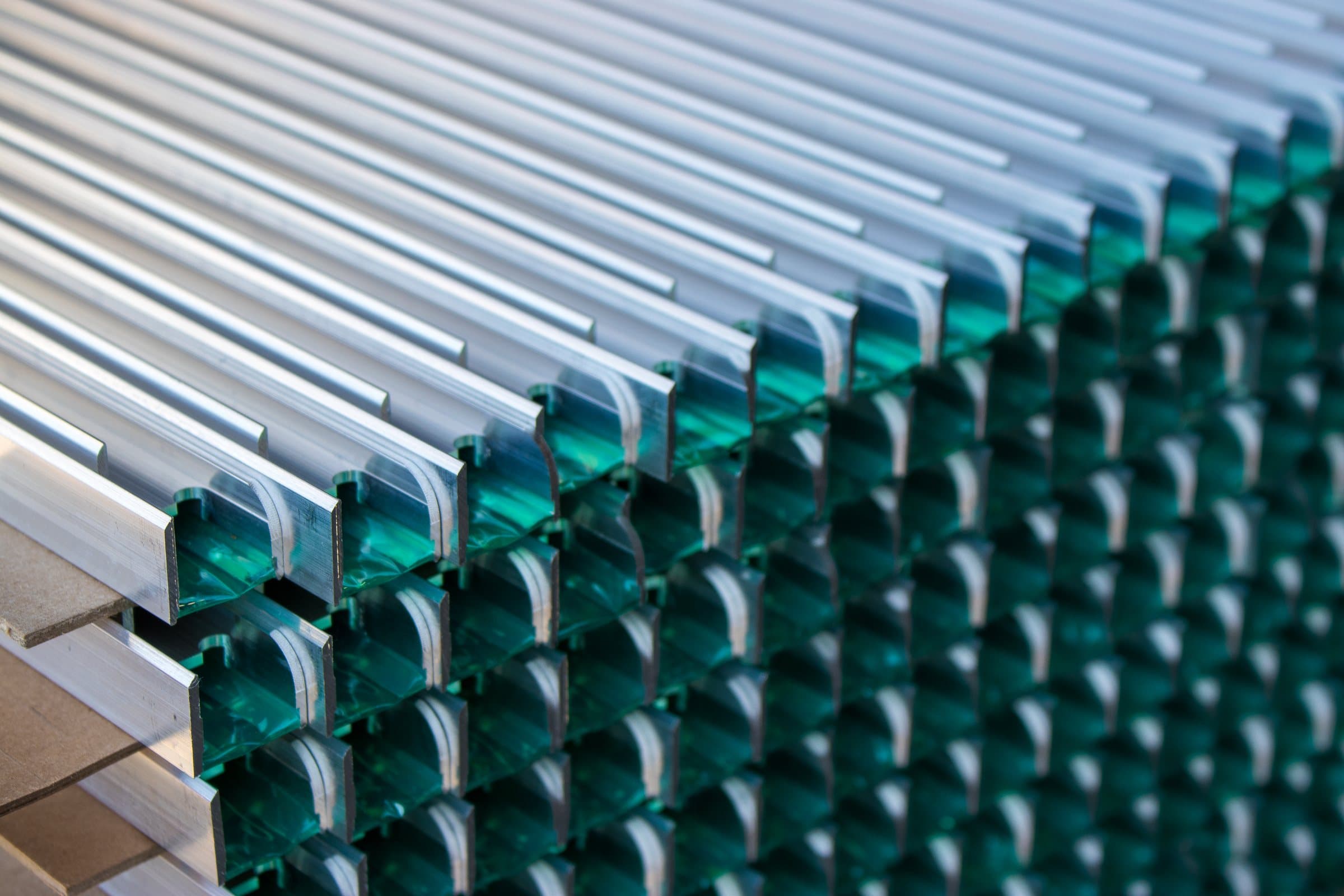 Custom aluminum extrusions with protective film staged for processing