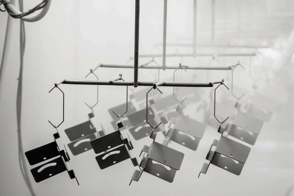 Coated sheet metal parts on racks
